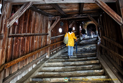 The covered passageway protects villagers making their way to the church