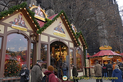 Locals, rugged up for the cold, join in the festive shopping