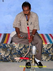 Smoking a water pipe.

Aswan - Nile River - Egypt