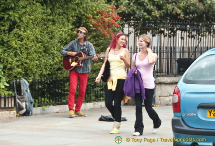 A busker in front of St John's Church