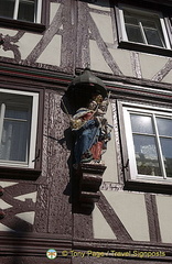 Timber-frame house with status of Mary with baby Jesus