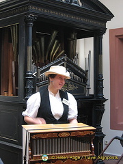 Museum guide demonstrating instrument