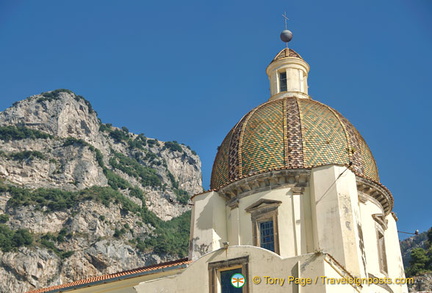 Green and yellow majolica tile dome of the Church of Our Lady of the Assumption which opens on Piazza Flavio Gioia