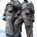 Three figures on a stone plinth