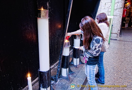 Offerings of candles by the faithful