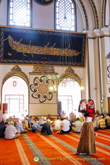 Prayer groups in session whilst tourists run around taking snaps