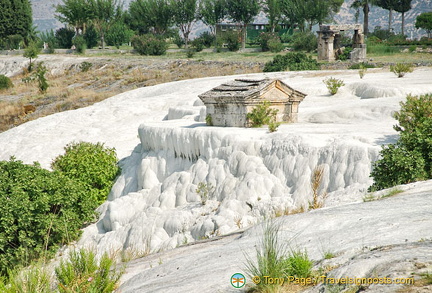 A sarcophagus submerged in travertine