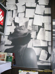 A traveller checking the message board of the Pudding Shop