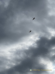 Helicopters fly over